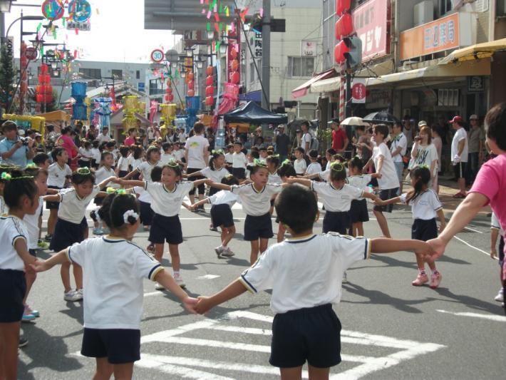 大勢の子どもが手を繋いで輪になっている様子