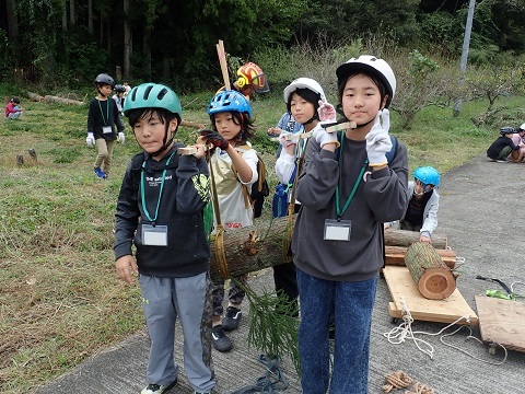 協力して木を運ぶ