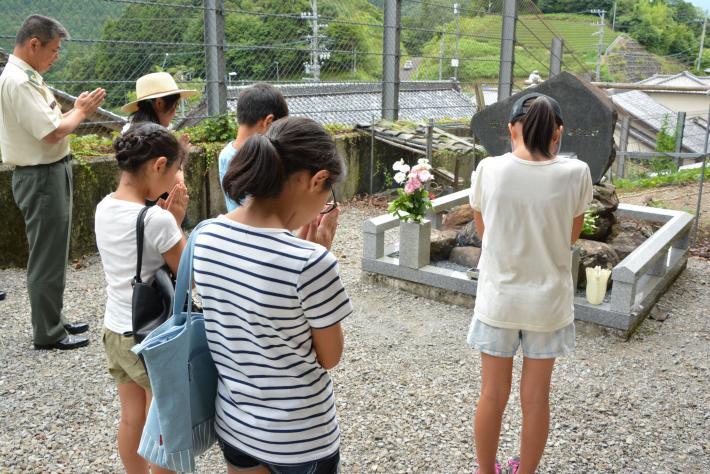 慰霊碑に向かって隊員の冥福を祈る参加者の写真